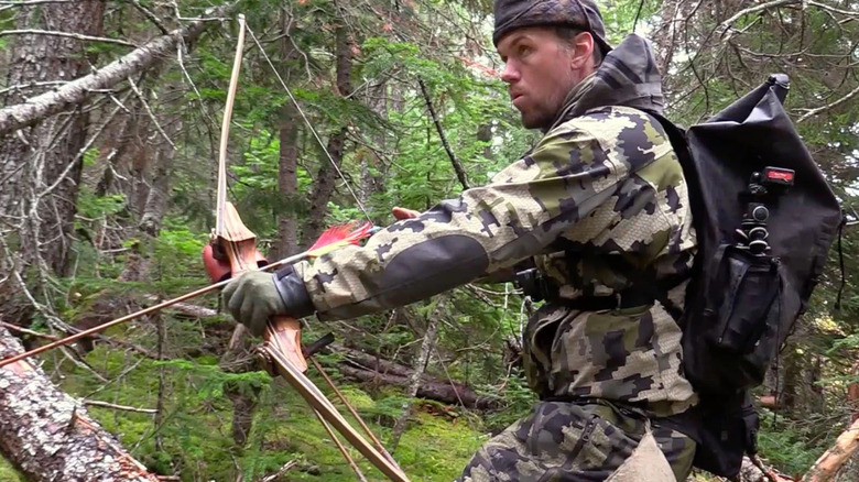 A man shooting a bow and arrow 