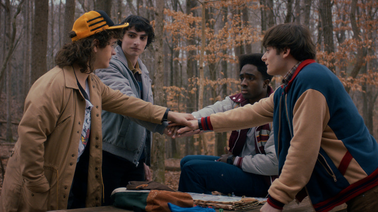 Dustin Mike Lucas and Will putting their hands in together on Stranger Things 5