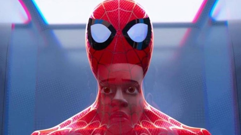 Miles Morales looking up at Spider-Man's suit in 