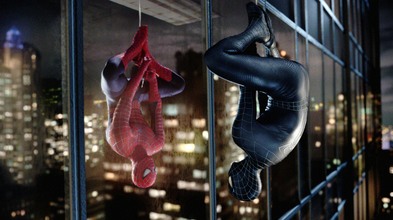 A black-suited Spider-Man gazes at his normal reflection in glass in "Spider-Man 3" (2007)