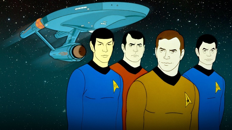 Kirk, Spock, Scotty, and Sulu stand before the Enterprise for Star Trek The Animated Series