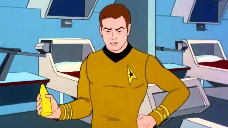 Kirk holds a yellow device while in sickbay in Star Trek: The Animated Series