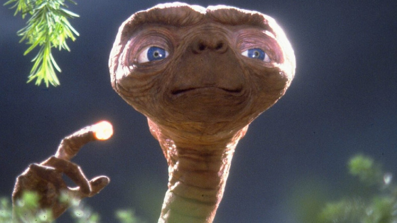 E.T. raises his lighted finger in 