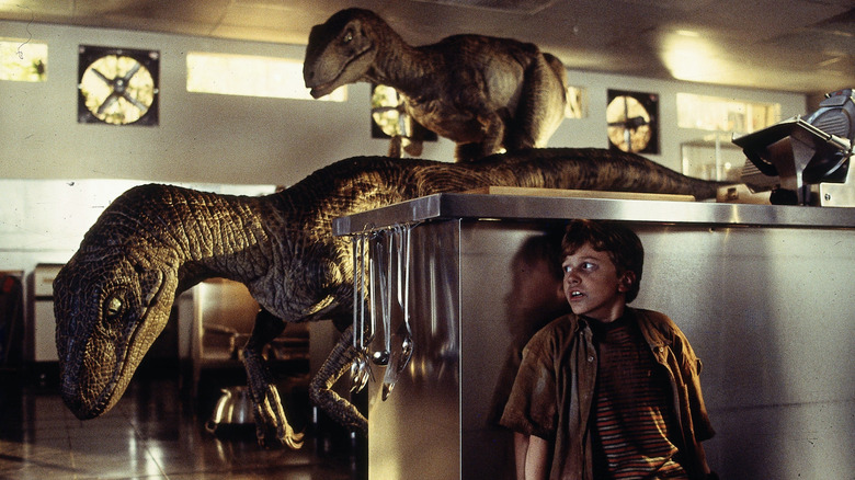 Tim hides in a kitchen from velociraptors in "Jurassic Park" (1993)