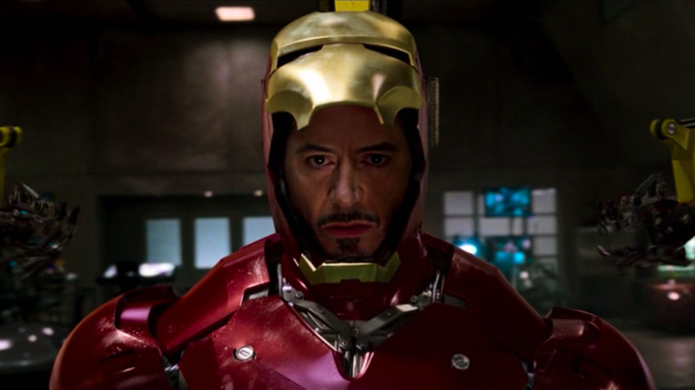 Tony with the Iron Man mask lifted up