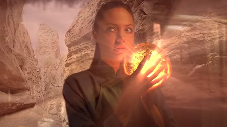 Lara Croft holding glowing globe