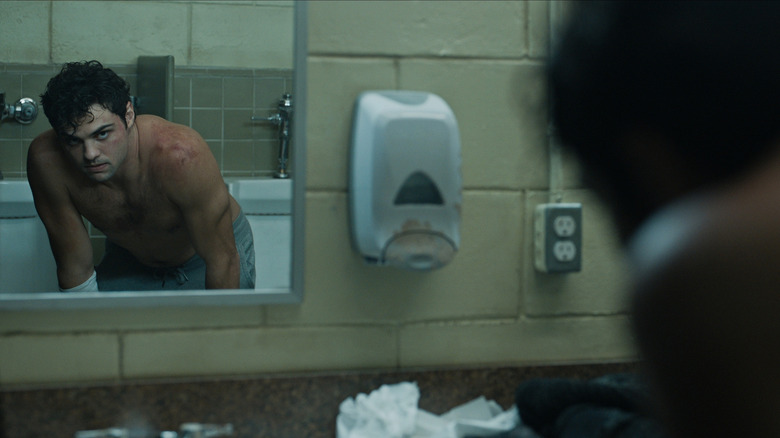 Owen stares at himself in the mirror in "The Recruit"