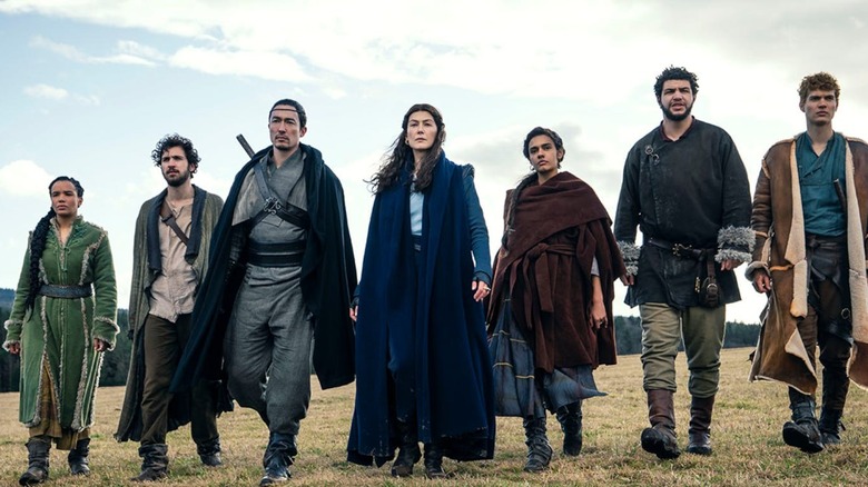 The cast strolls confidently along the countryside in "Wheel of Time"