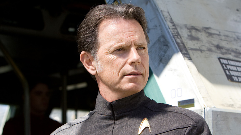 Captain Pike stands outside a ship in "Star Trek" (2009)