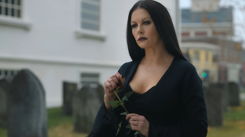 Morticia Addams crushing a flower 