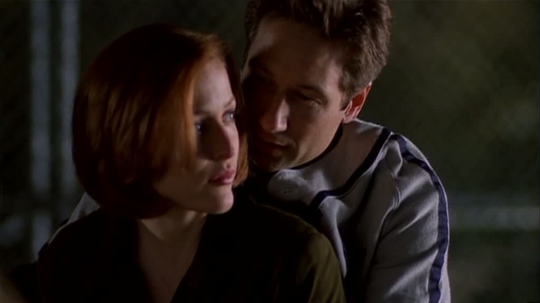 Mulder teaching Scully how to swing a baseball bat