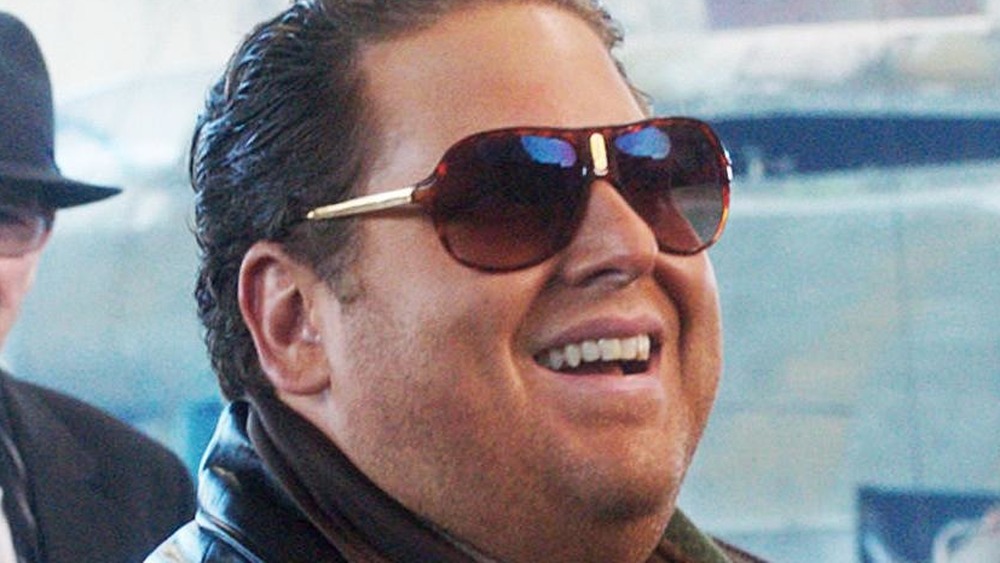 Jonah Hill smiles in sunglasses