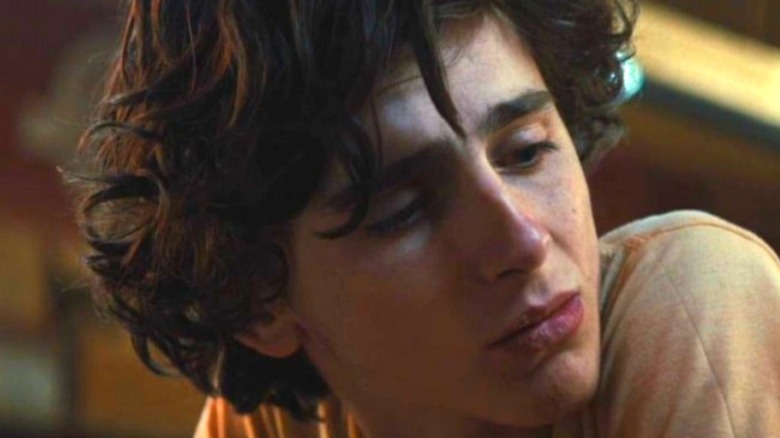 Upset Timothee Chalamet looks down to side