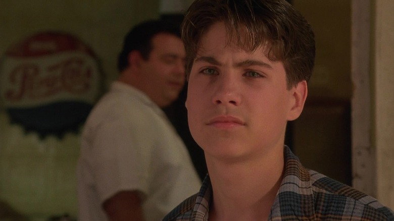 Young Henry Hill standing outside
