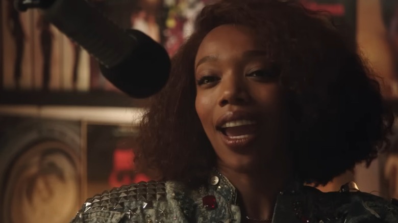 Whitney Houston speaking into microphone