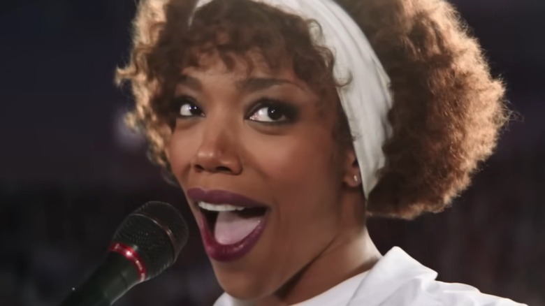 Whitney Houston singing into microphone