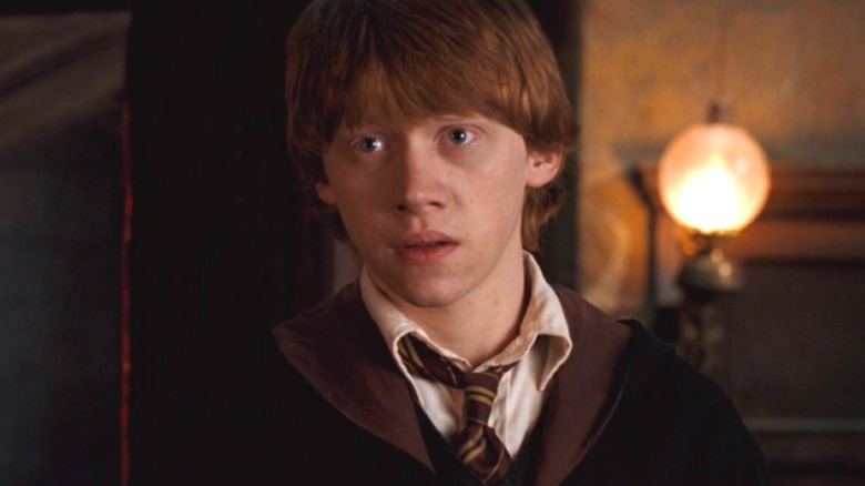 Ron Weasley sitting on the Hogwarts Express