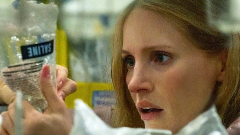 The Good Nurse's Jessica Chastain looking worried at saline bag