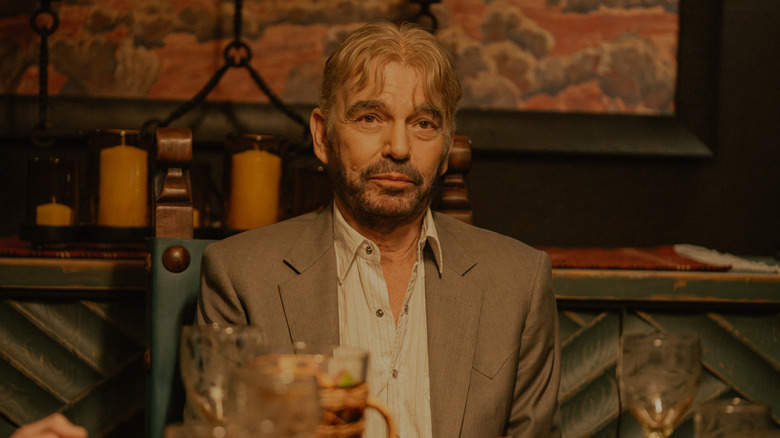 Tommy is bleary-eyed at the dinner table in 