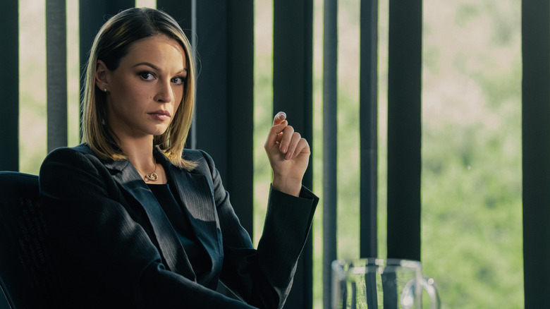 Rebecca sits by a window in "Landman"