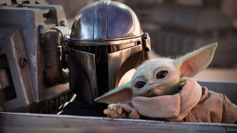 The Mandalorian and Grogu looking over from their ship in 