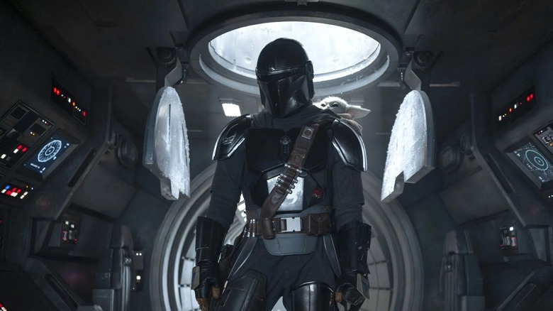 The Mandalorian and Grogu standing inside an AT-AT in "The Mandalorian and Grogu" (2026)