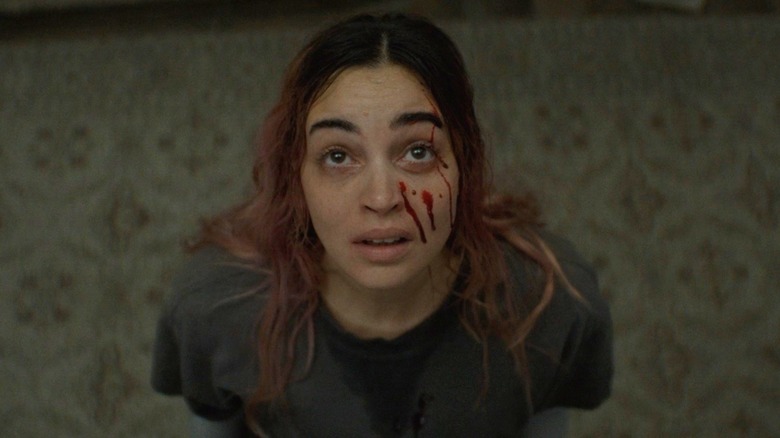 Alice looking up with blood drops on her face in Evil Dead Burn (2026)