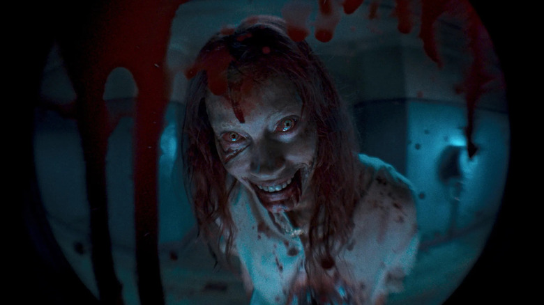 Possessed Ellie waiting outside the apartment in Evil Dead Rise (2023)