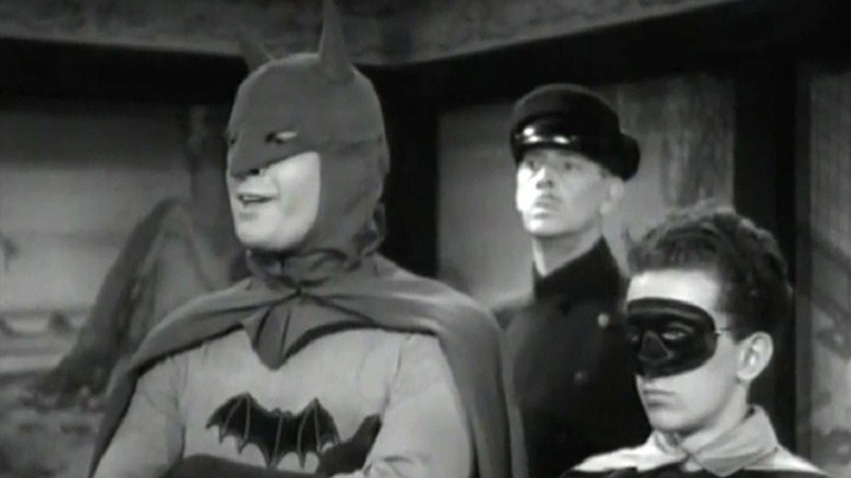 Batman and Robin stand side by side