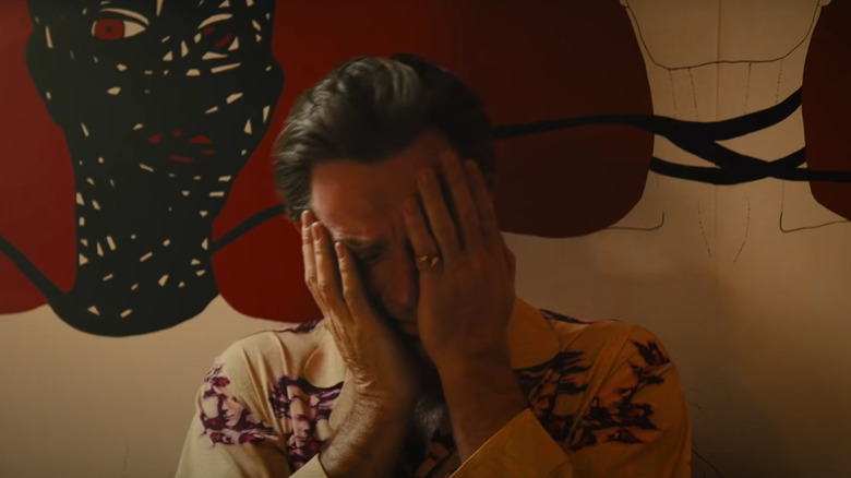 Roman Sionis rubs his face in exasperation