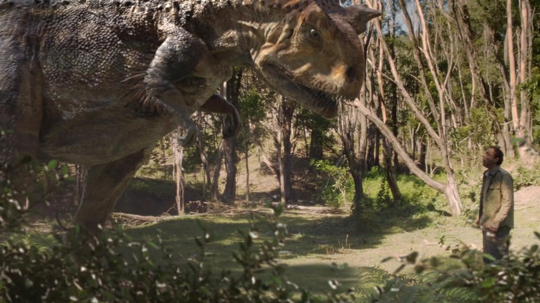 A dinosaur confronting a wayward human in Terra Nova (2011)