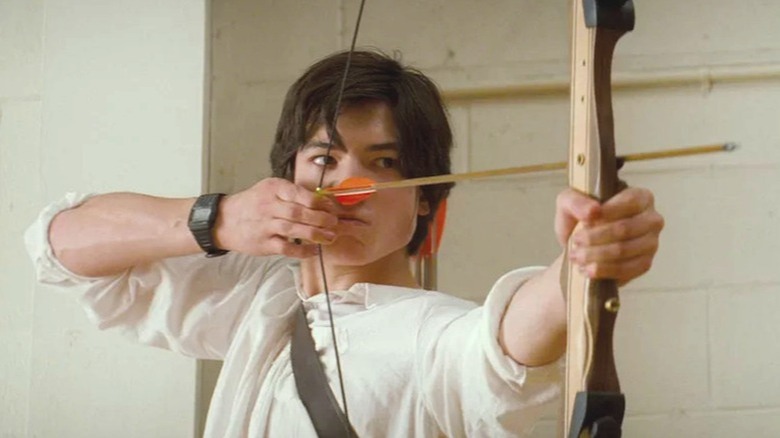 Kevin aiming with a bow and arrow
