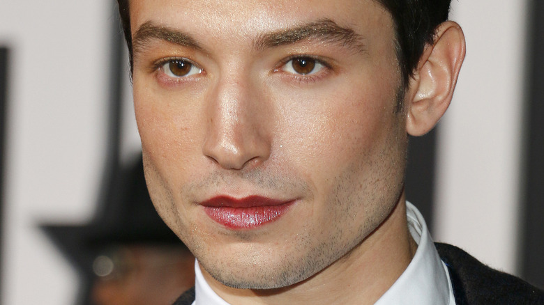 Ezra Miller wearing lipstick and a suit
