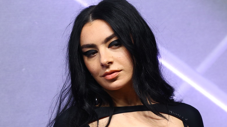 Charli XCX smirks demurely