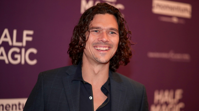 Luke Arnold attends a premiere