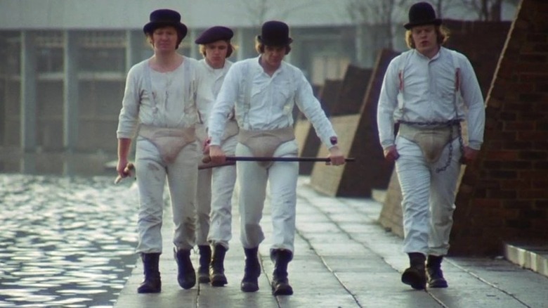 Droogs walking by river