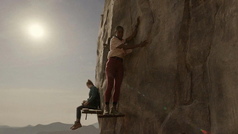 Jax sitting with Luce walking on the support beams in Fall 2: Deadpoint