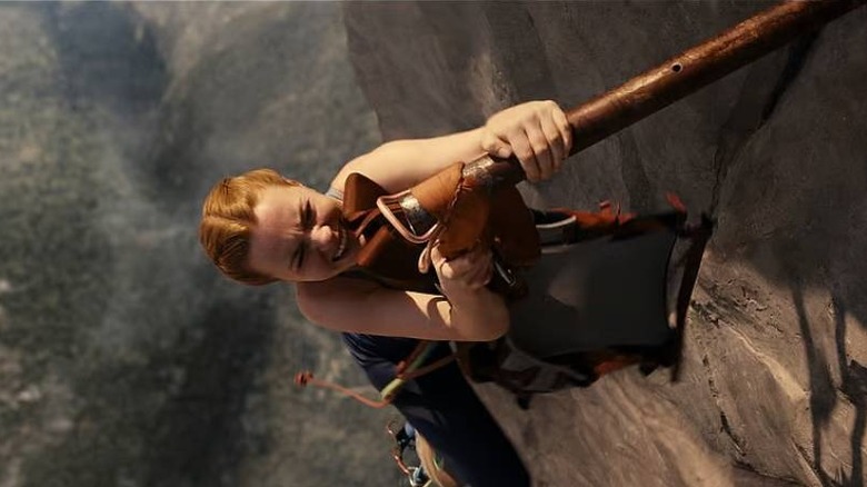 Jax pulling a backpack from a pole in Fall 2: Deadpoint