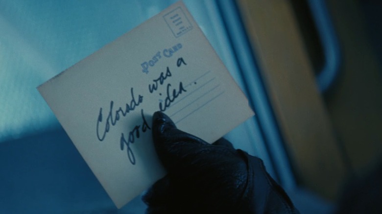 The Ghoul holding Colorado postcard