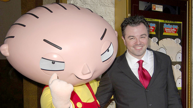 Seth MacFarlance poses with a Stewie Griffin mascot