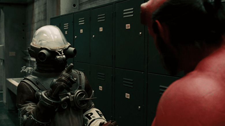 Krauss talks to Hellboy in a locker room in
