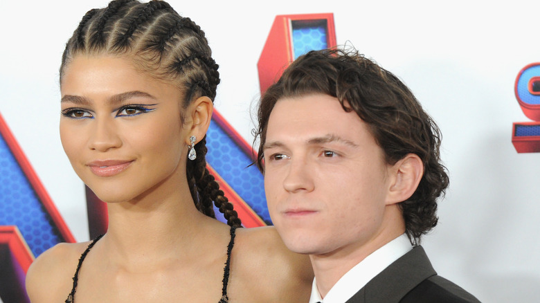 Zendaya stands beside Tom Holland