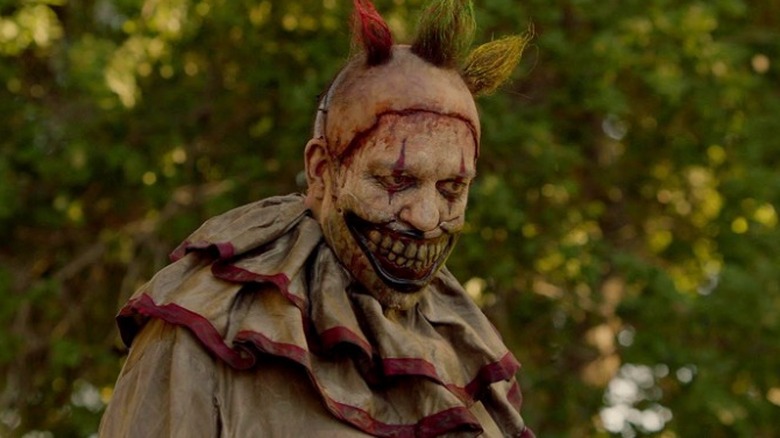 Twisty stares at the ground amid trees