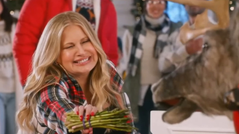 Jennifer Coolidge feeding a reindeer