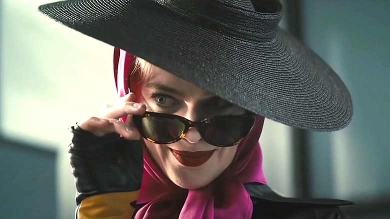 Harley Quinn peers over her sunglasses