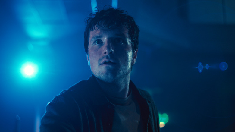 Josh Hutcherson stands by a blue light