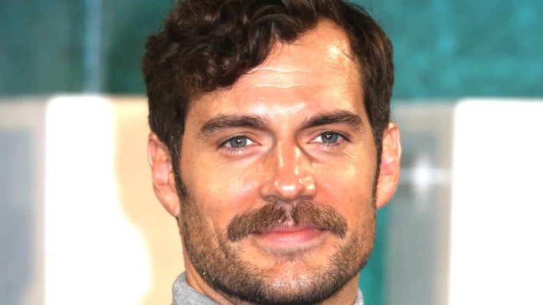 Henry Cavill with mustache, smiling