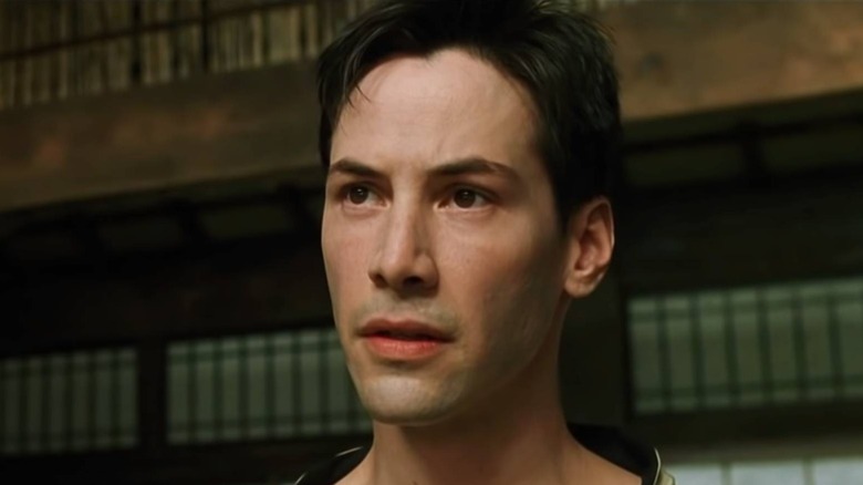 Keanu Reeves playing Neo in The Matrix