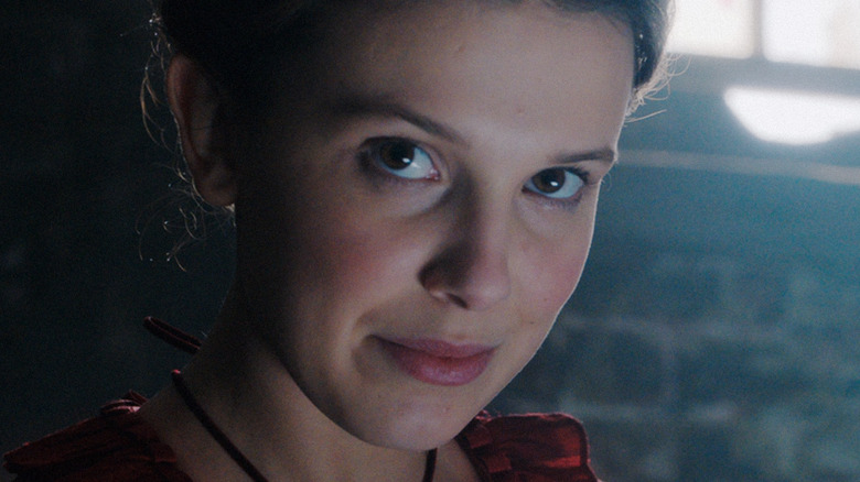 Millie Bobby Brown as Enola Holmes looking at camera