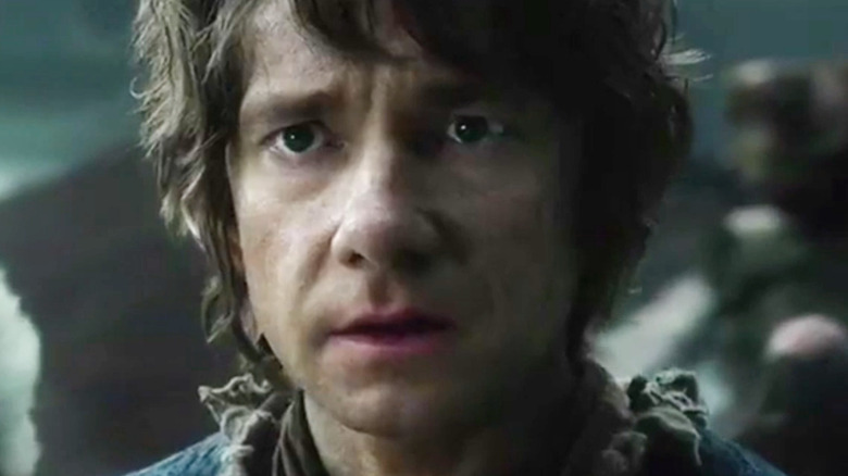 Bilbo staring suspiciously at the dwarves